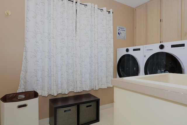 washroom with cabinets and independent washer and dryer