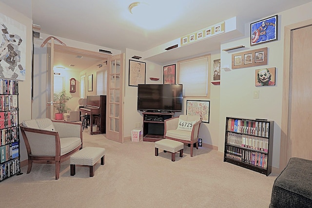 living area featuring light carpet