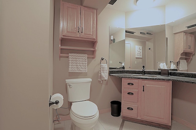 bathroom with tile patterned floors, vanity, and toilet