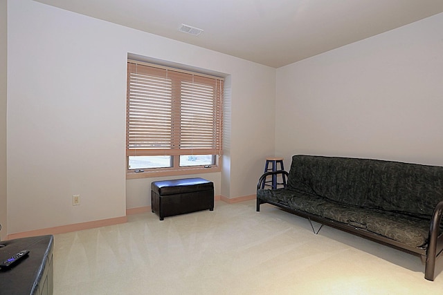 sitting room featuring light carpet