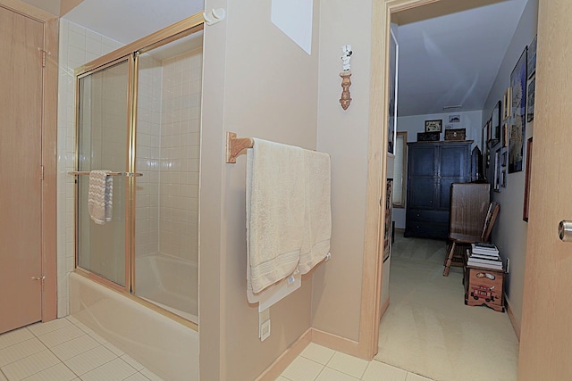 bathroom with tile patterned flooring and shower / bath combination with glass door