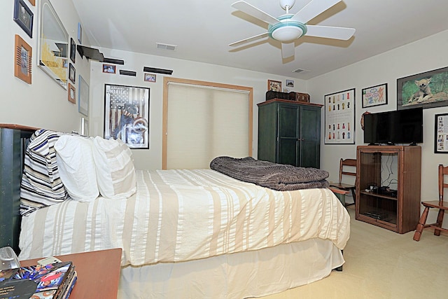 bedroom featuring light colored carpet and ceiling fan