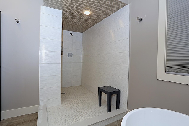 bathroom featuring separate shower and tub