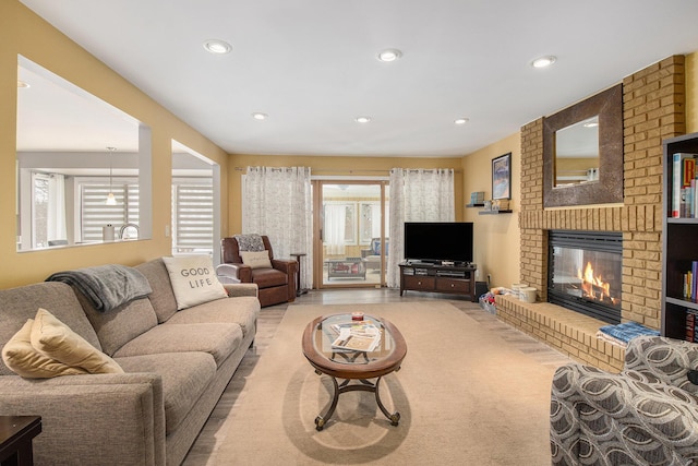 carpeted living room with a brick fireplace