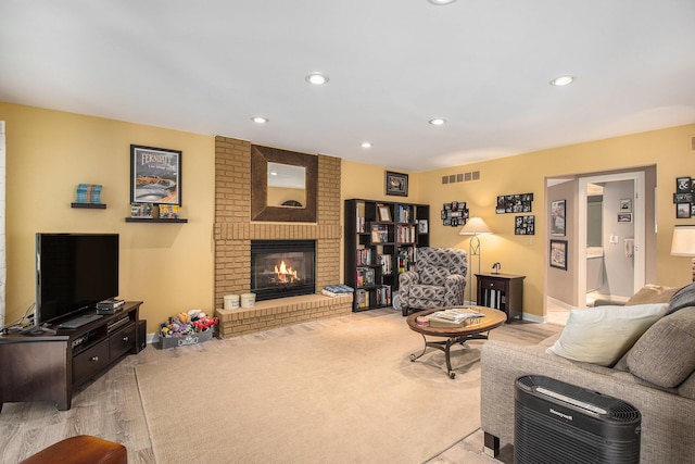 living room featuring a brick fireplace