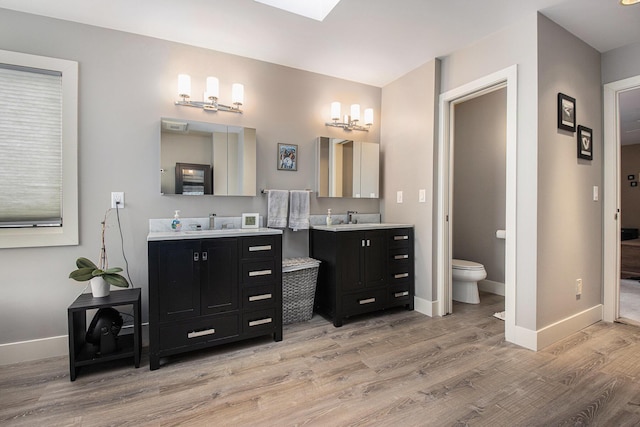 bathroom with vanity, hardwood / wood-style floors, and toilet