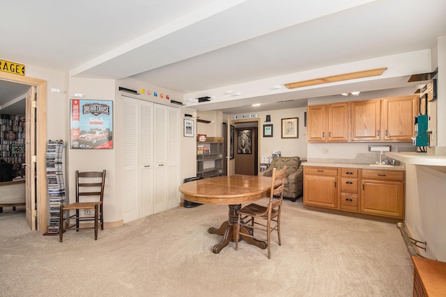 dining area featuring light carpet