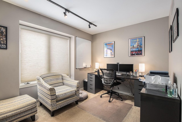 home office with light carpet and track lighting