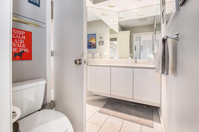 bathroom with vanity, tile patterned floors, and toilet