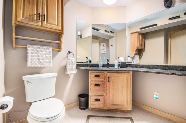 bathroom featuring vanity, tile patterned floors, and toilet