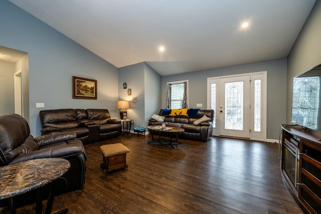 living room featuring dark wood-type flooring and vaulted ceiling