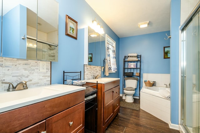 full bathroom featuring vanity, tasteful backsplash, wood-type flooring, independent shower and bath, and toilet