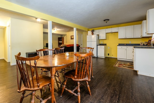 dining space featuring dark hardwood / wood-style floors