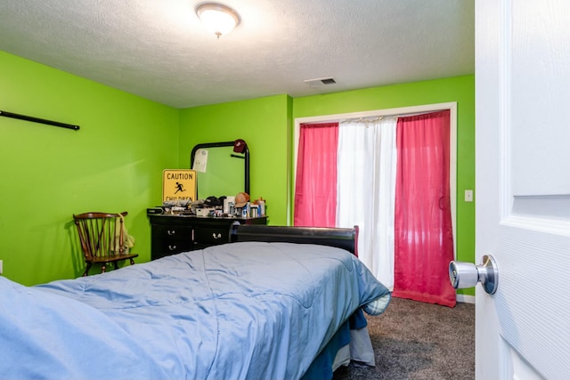 carpeted bedroom with a textured ceiling