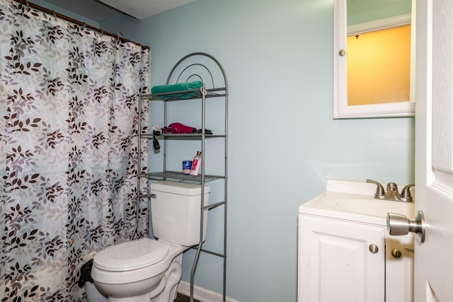 bathroom featuring vanity, curtained shower, and toilet