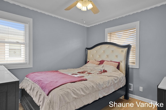 bedroom with ceiling fan and wood-type flooring