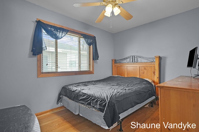 bedroom featuring hardwood / wood-style floors and ceiling fan