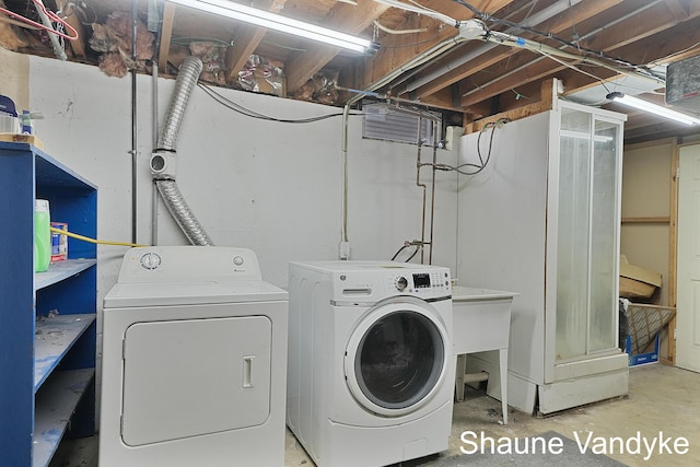 washroom with washing machine and clothes dryer