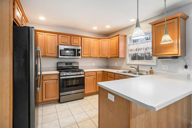 kitchen with sink, light tile patterned floors, kitchen peninsula, pendant lighting, and stainless steel appliances