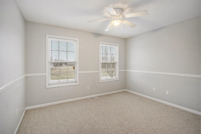 spare room with ceiling fan and carpet flooring