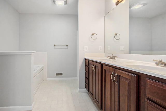 bathroom featuring vanity and a washtub