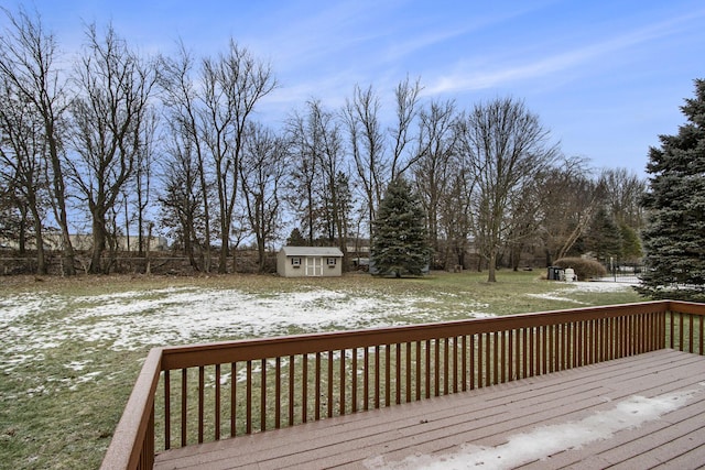 snow covered deck with a storage shed