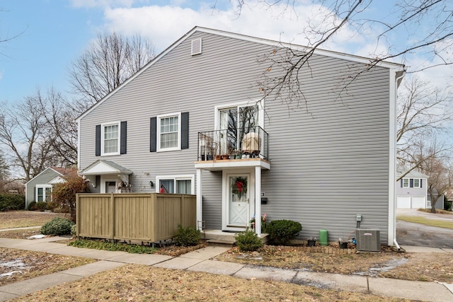 view of front of home with cooling unit and a balcony