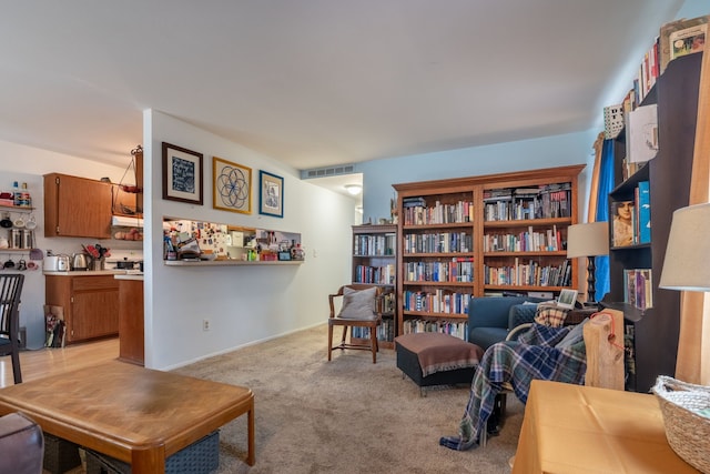 living area with light colored carpet