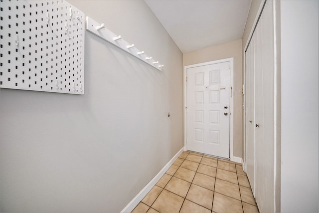 doorway to outside with light tile patterned floors