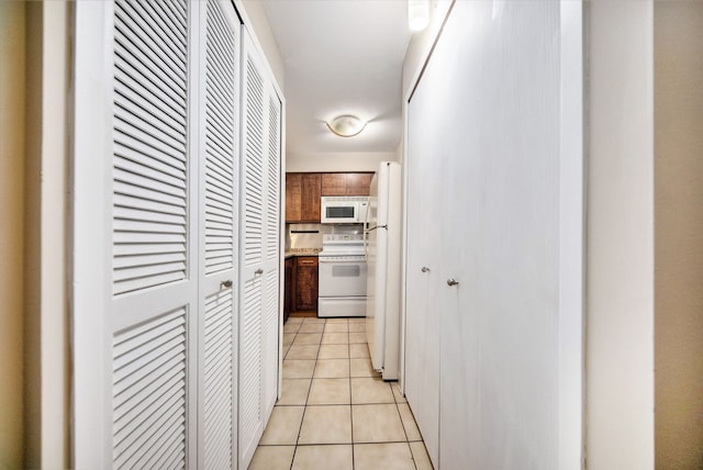 corridor with light tile patterned floors