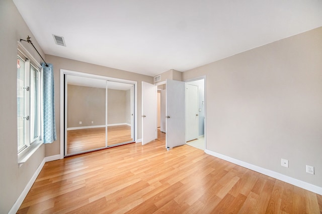 unfurnished bedroom with light wood-type flooring