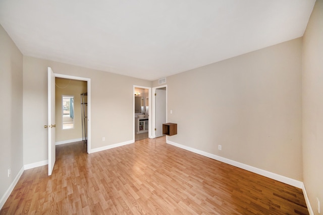 spare room featuring light hardwood / wood-style flooring