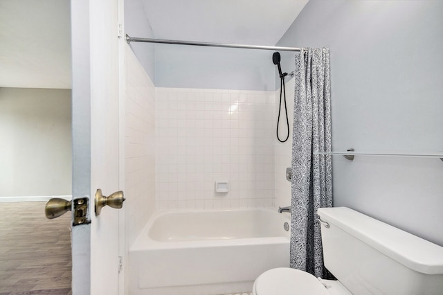 bathroom featuring wood-type flooring, shower / tub combo, and toilet