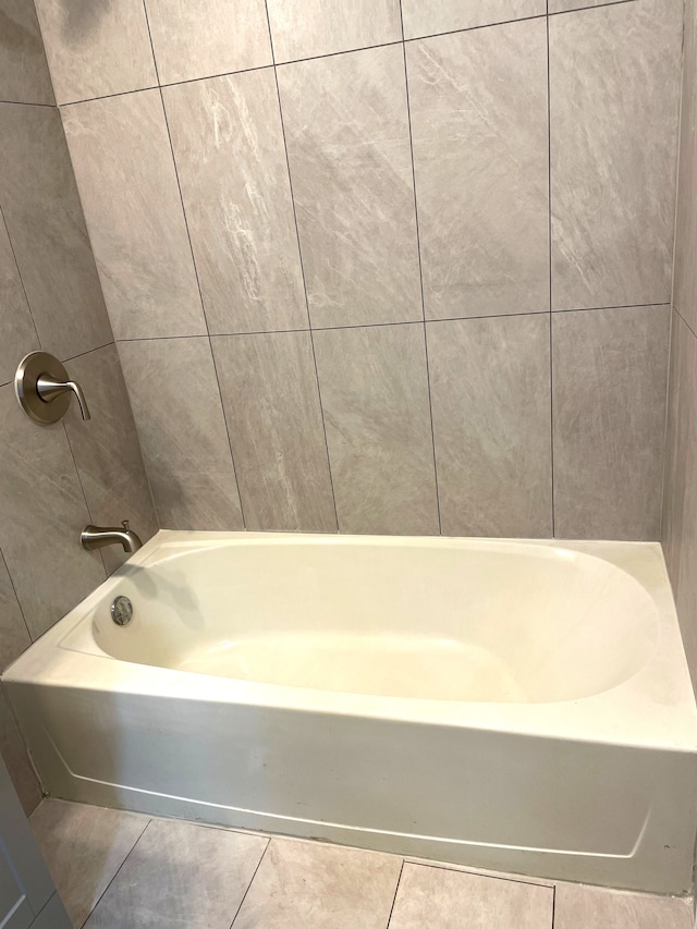 bathroom with tile patterned flooring and a bathing tub