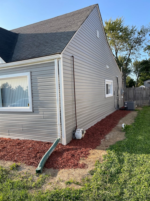 view of side of home with central AC