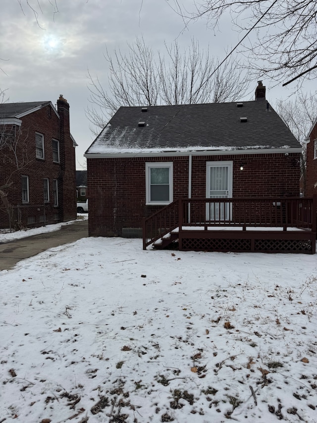 view of snow covered rear of property