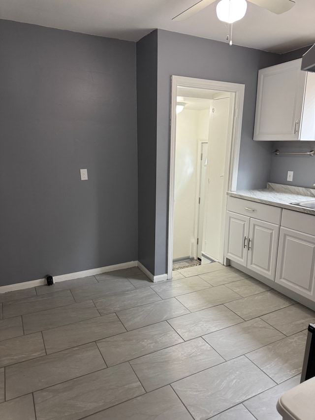 unfurnished dining area featuring ceiling fan and sink