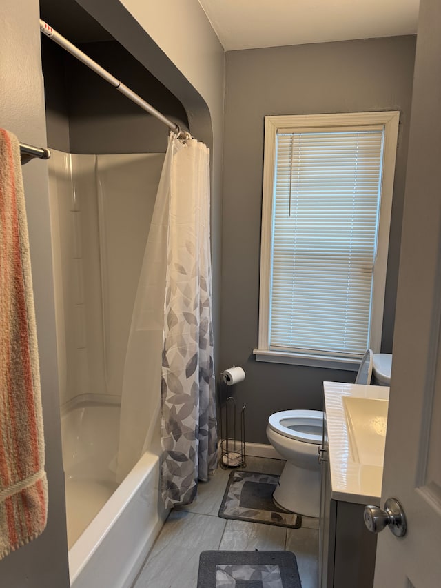 full bathroom with vanity, shower / tub combo, and toilet