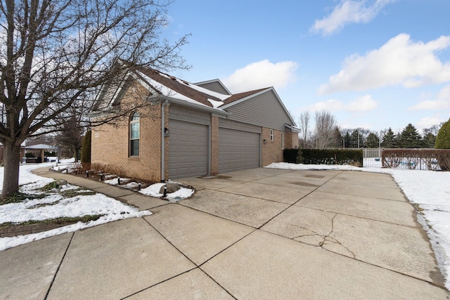 snow covered property featuring a garage