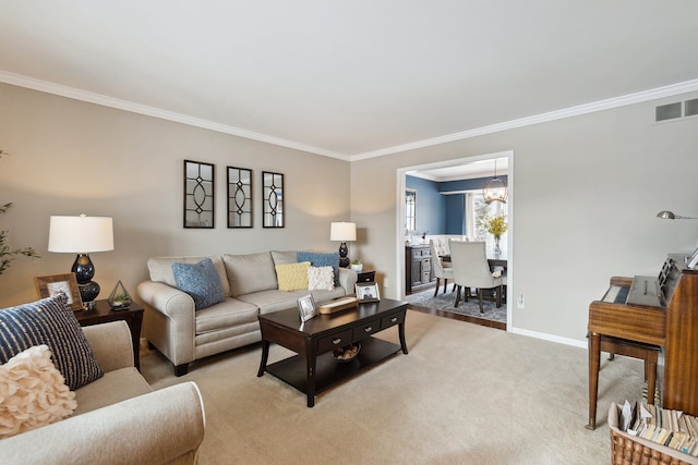 carpeted living room featuring ornamental molding and a chandelier