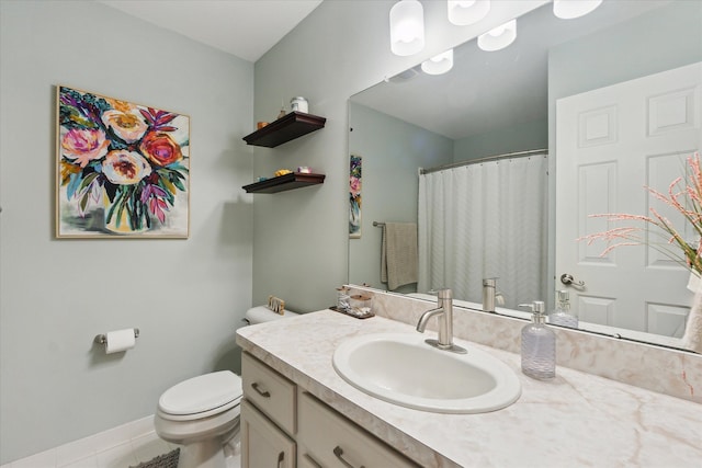 bathroom with vanity, tile patterned floors, and toilet