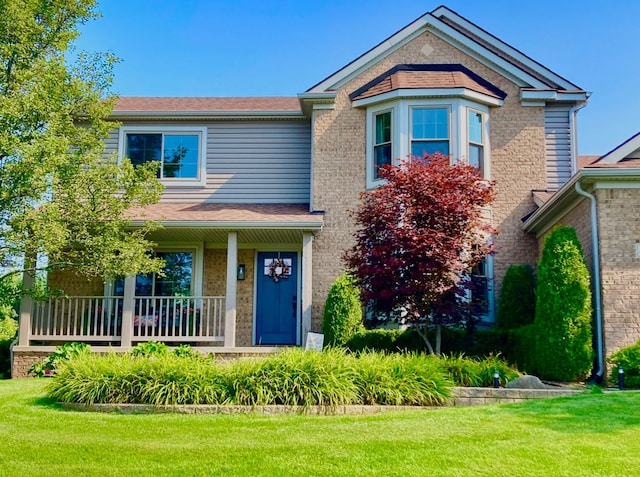 view of front of home featuring a front lawn and a porch