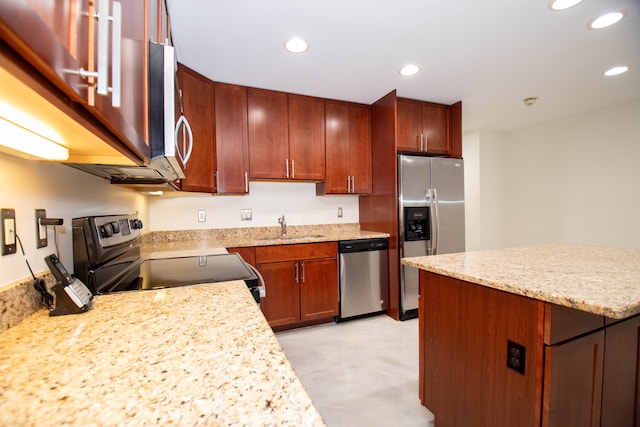 kitchen with stainless steel appliances, light stone counters, a sink, and recessed lighting