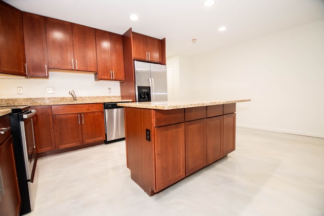 kitchen with appliances with stainless steel finishes, recessed lighting, a center island, and light stone counters