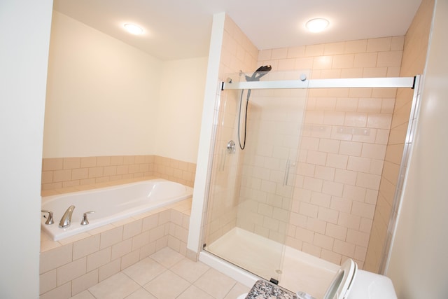 bathroom with a garden tub, tile patterned flooring, and a shower stall