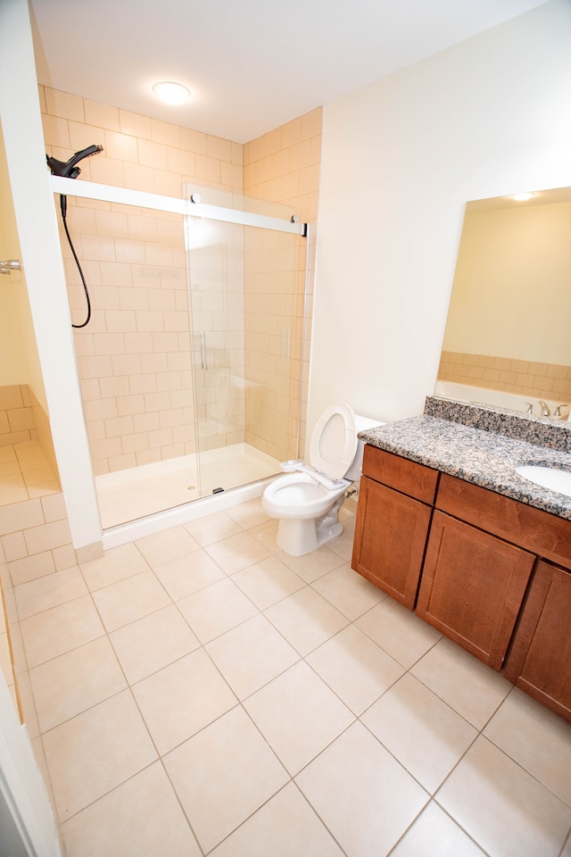 full bathroom with a stall shower, vanity, toilet, and tile patterned floors