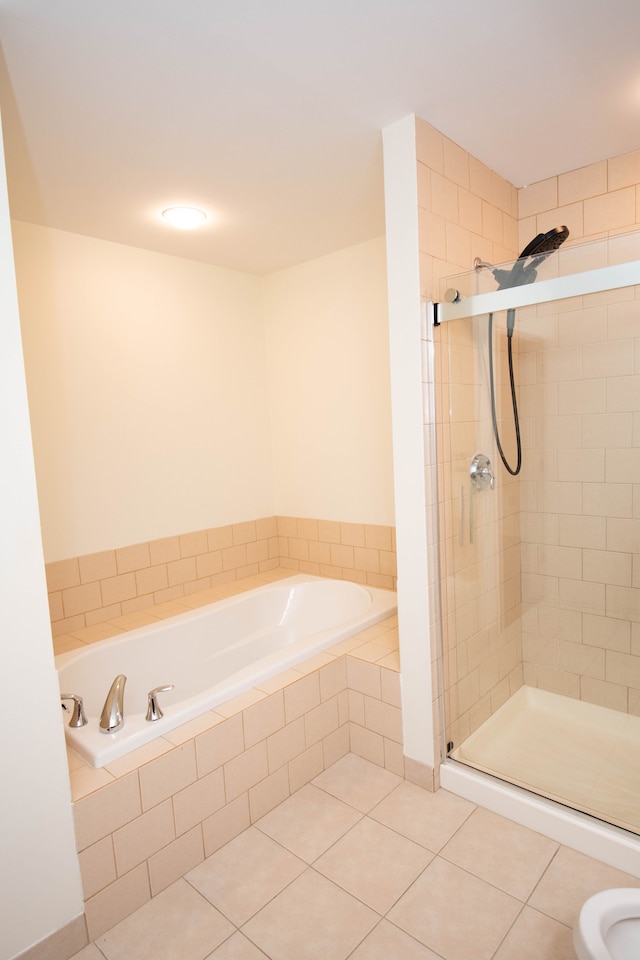 full bathroom with a stall shower, a garden tub, and tile patterned floors