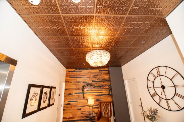 details with wooden walls and a notable chandelier