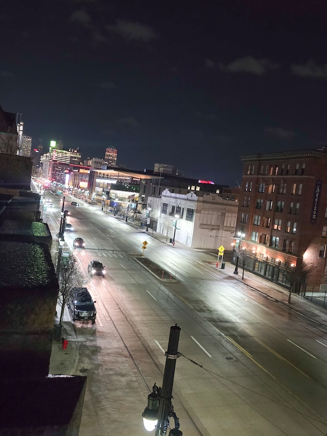 view of road featuring street lights, curbs, and sidewalks