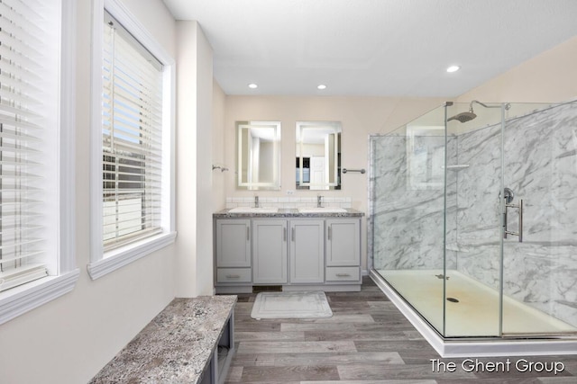 bathroom with vanity, a shower with door, and hardwood / wood-style floors